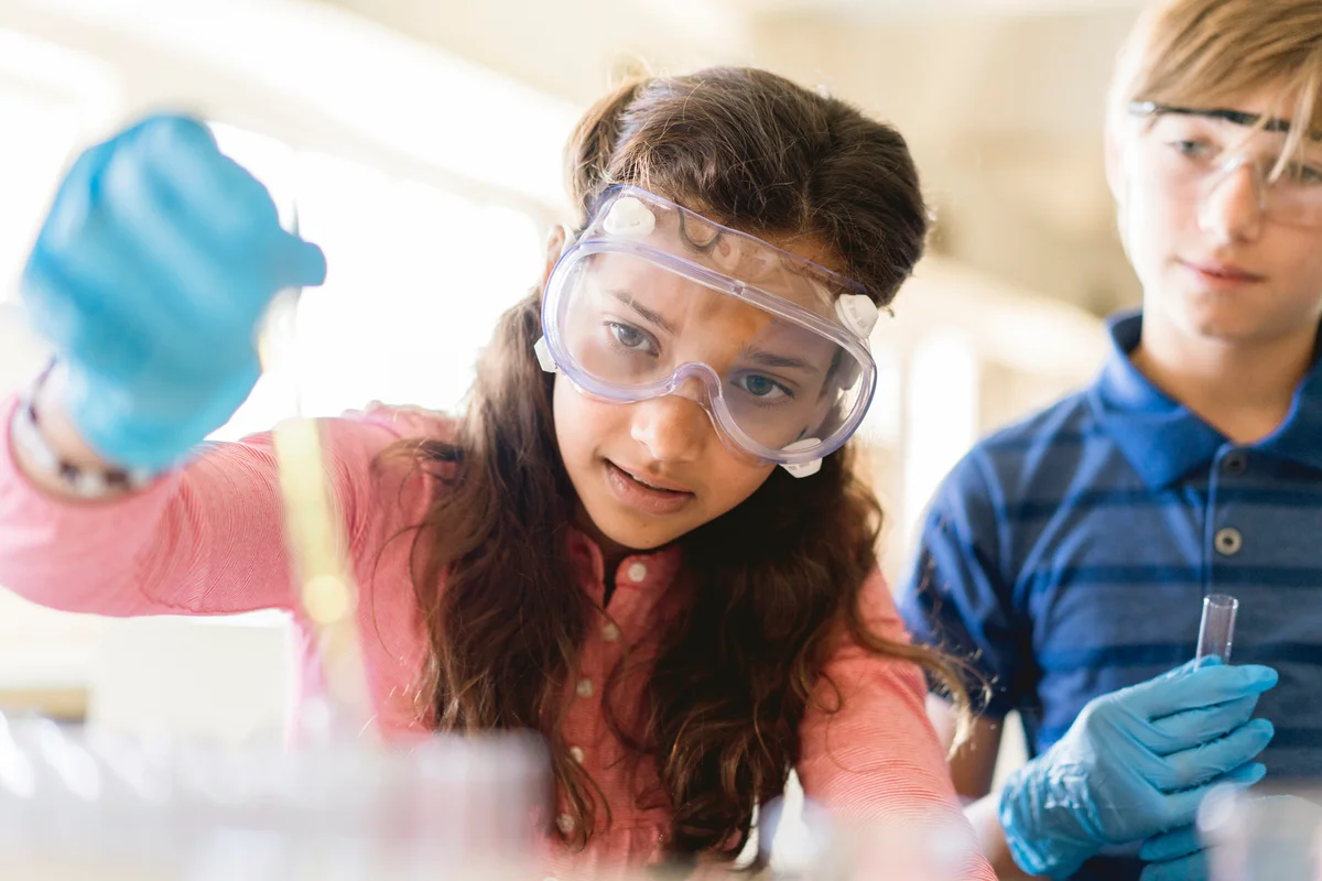 Students doing scientific experiment in classroom
