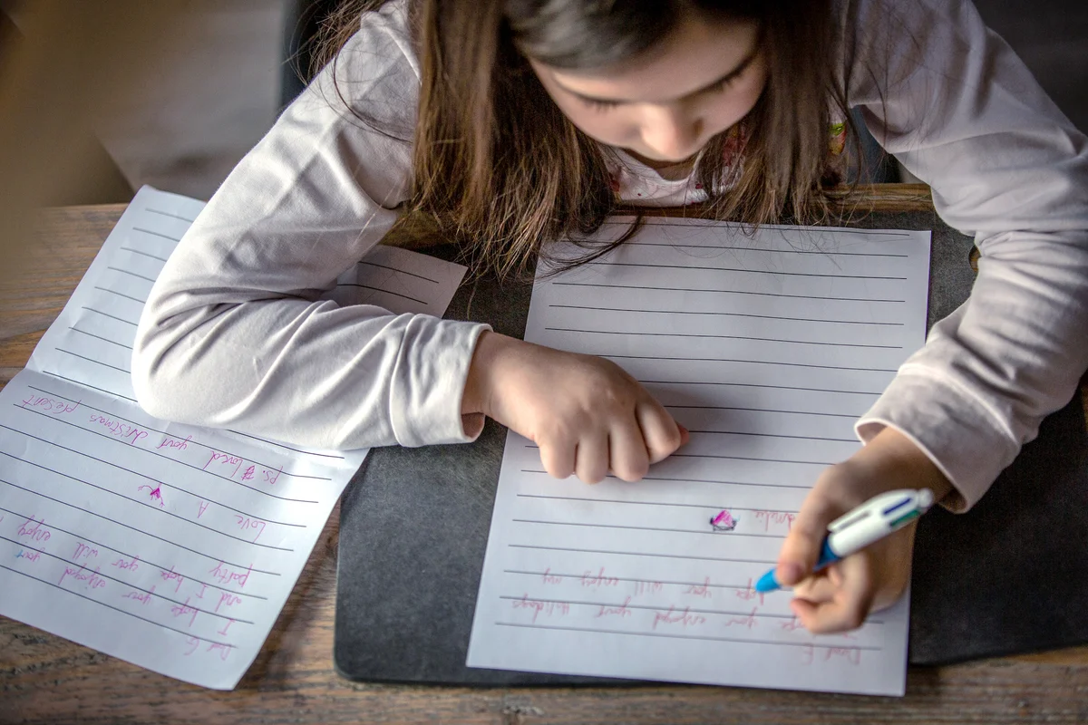 Child writing letter by herself