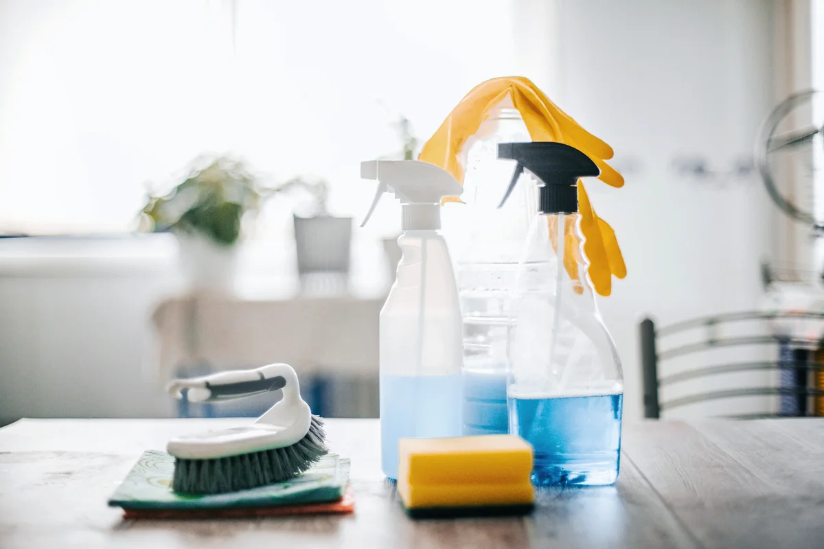 Collection of cleaning supplies on surface of the kitchen table