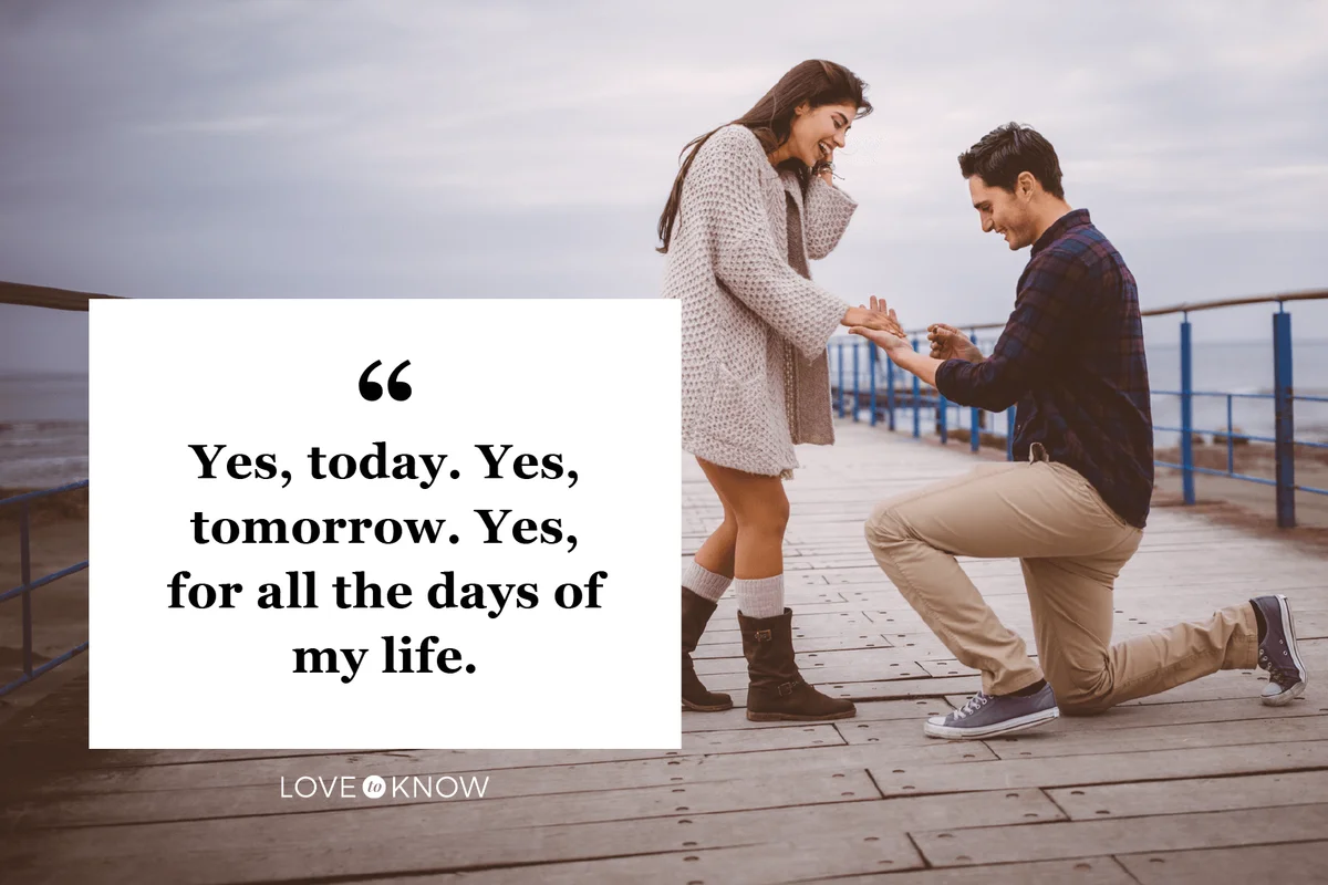 Man kneeling down proposing to his lover on a pier next to the sea