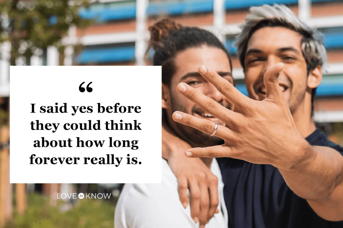 Smiling man showing engagement ring while standing by gay partner in park