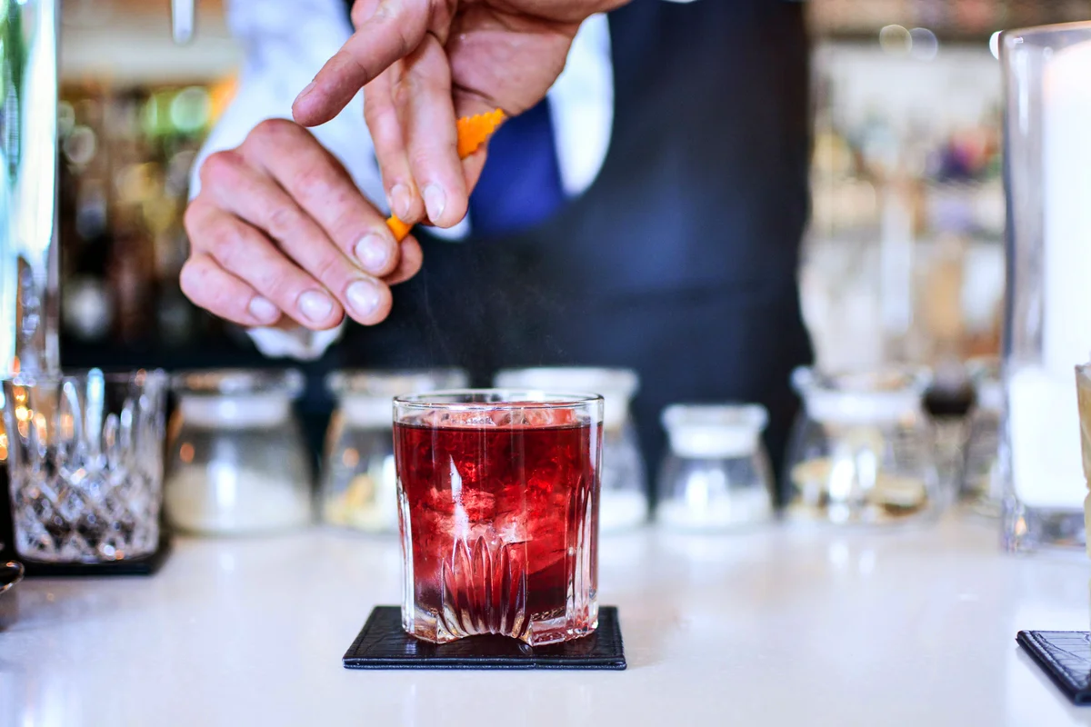 Bartender Preparing Cocktail At Counter