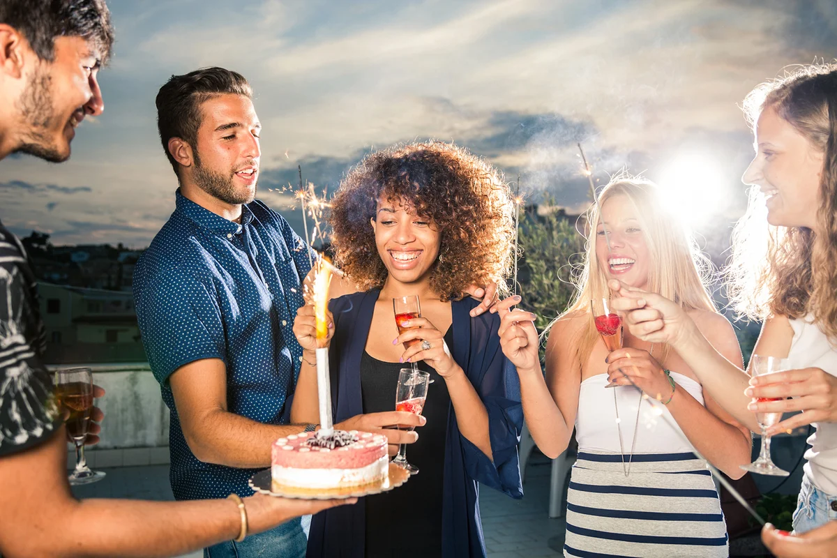 Friends celebrating a birthday party on a rooftop