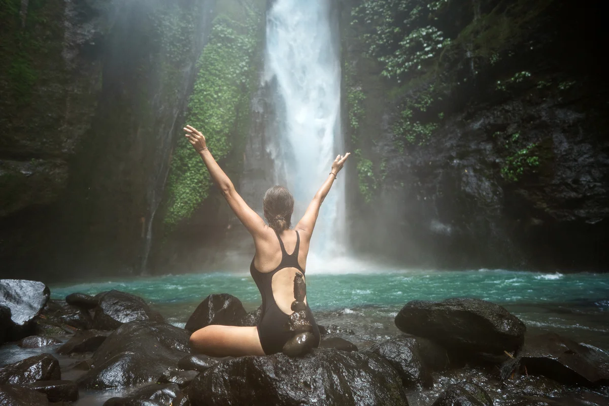 Woman in waterfall