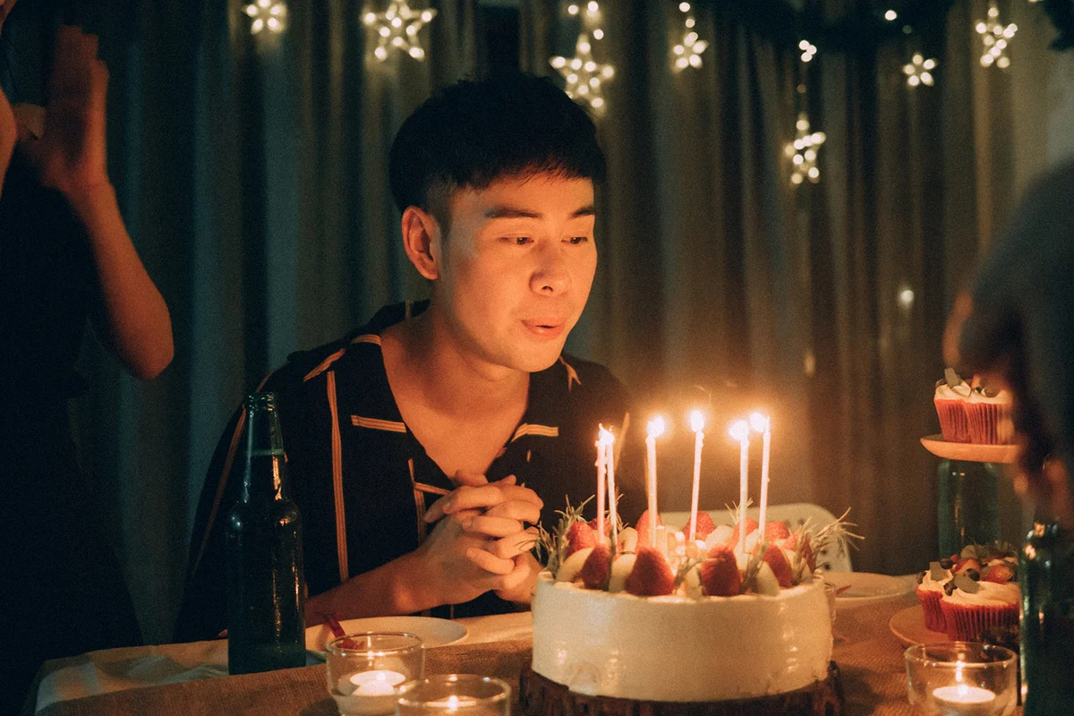 Man blowing birthday candles