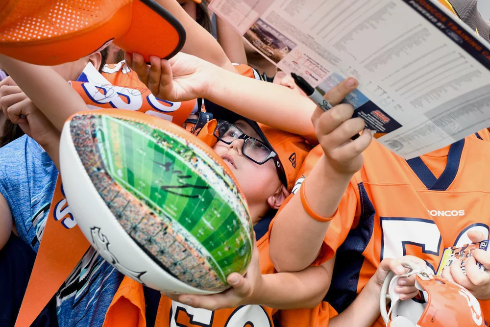 Fans who jostle for a chance to get memorabilia signed