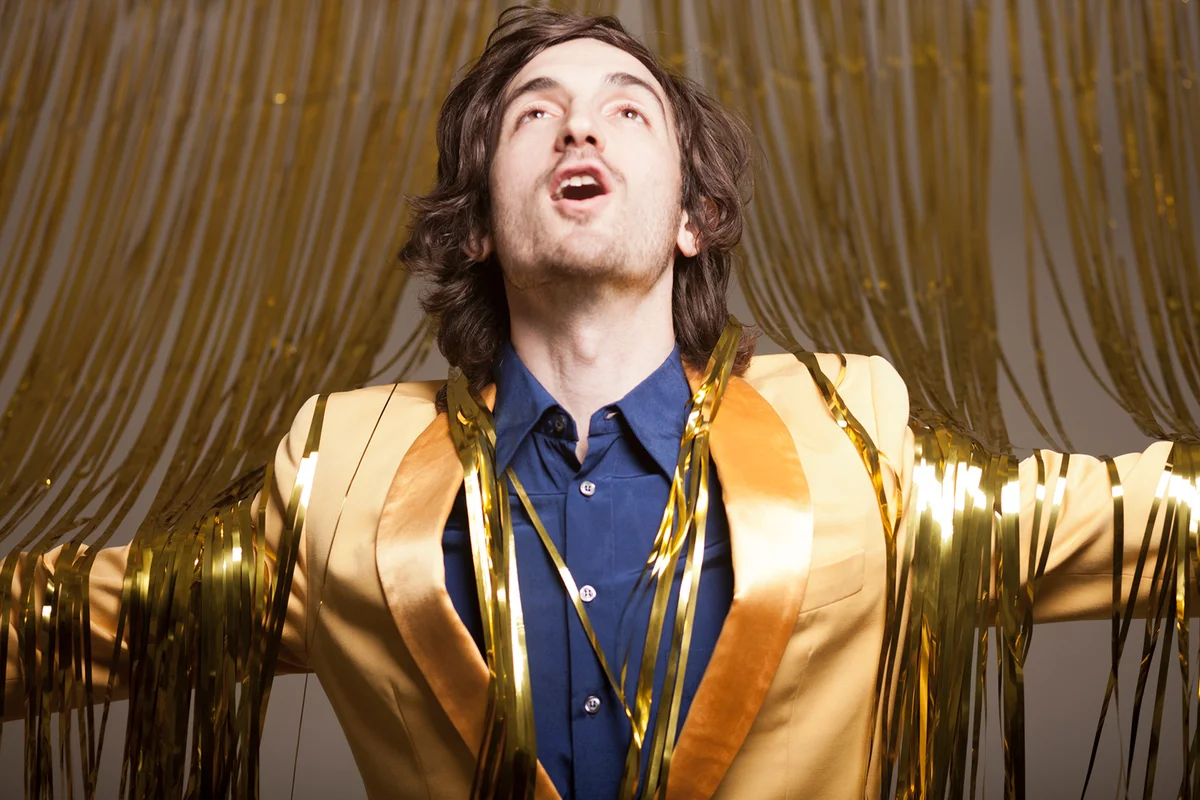 Young adult man wearing a golden suit