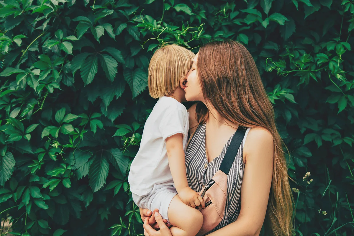 Mother hugging her child during walk in the park