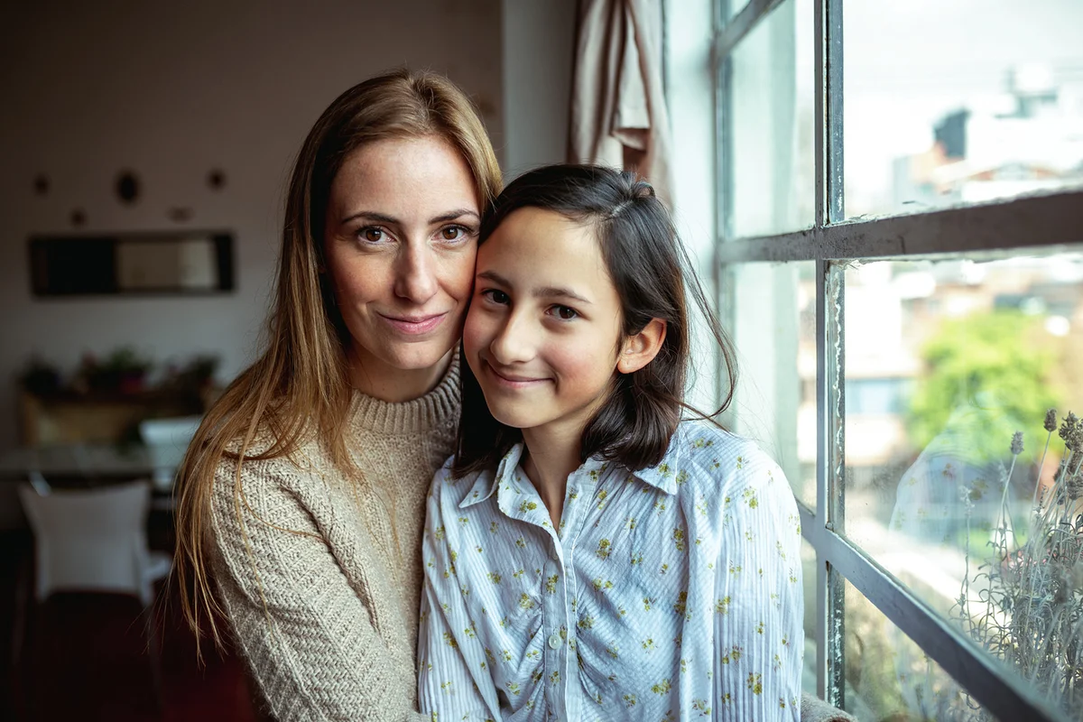 Mother and daughter portrait near window