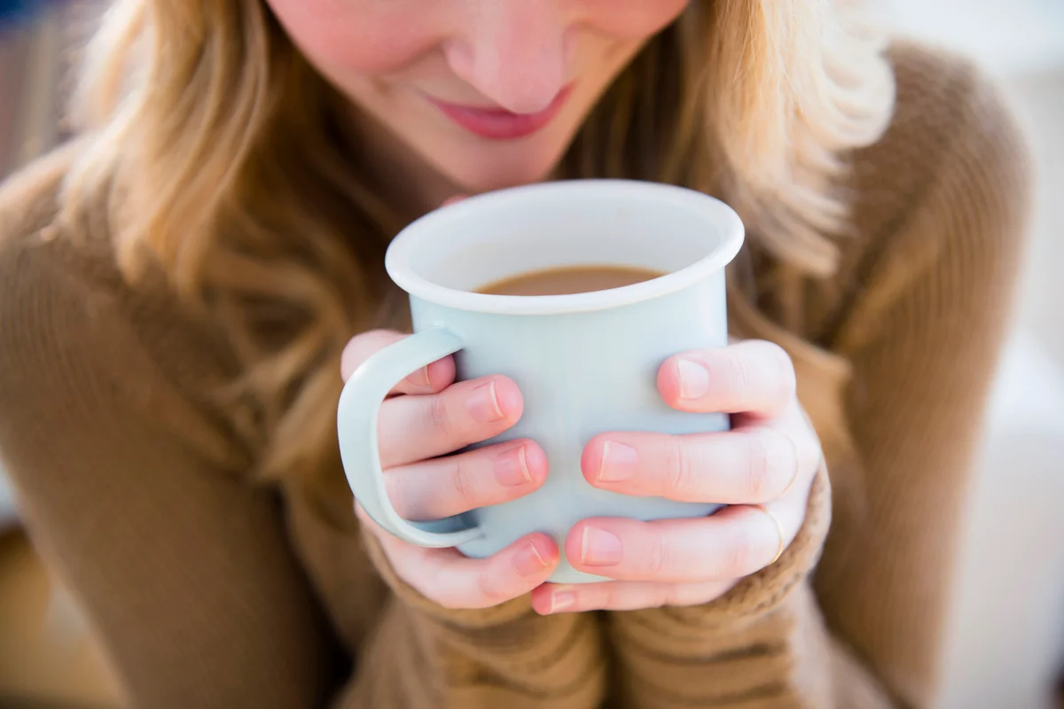Woman holding coffee mug