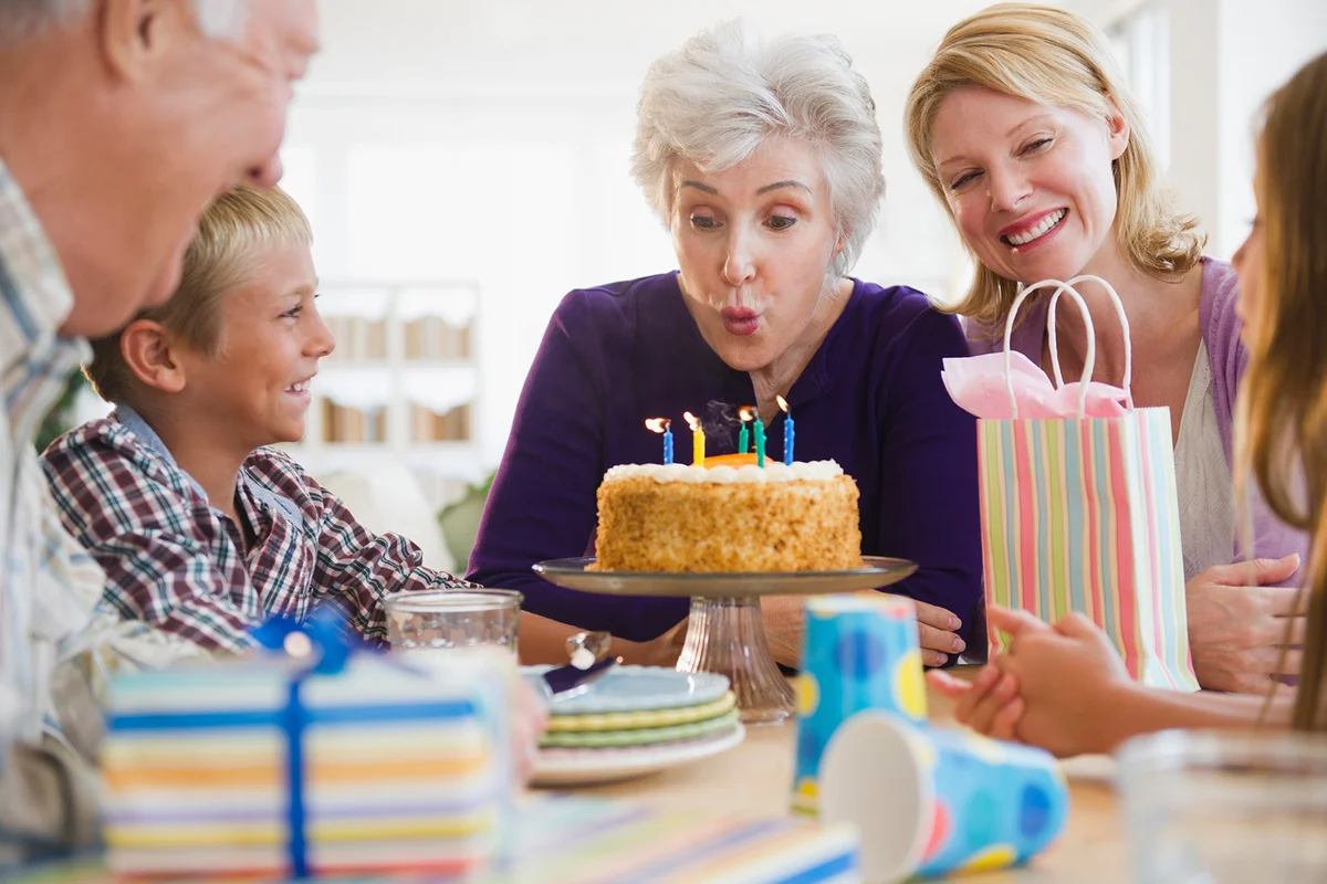Grandmother blowing out 75th birthday candles