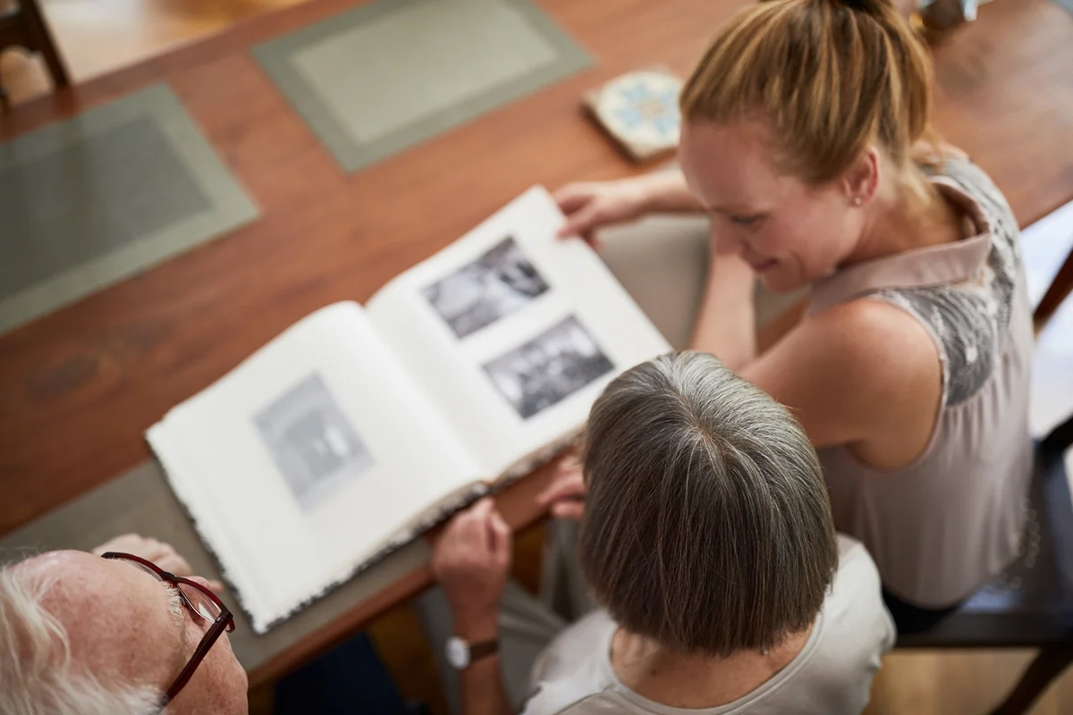 Woman with her parents looking a photo album