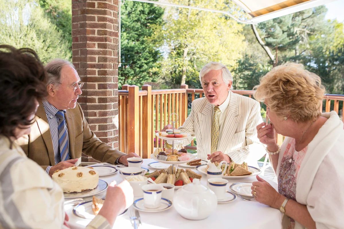 Senior people having tea on the balcony