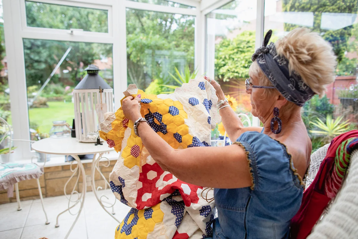 Senior woman busy making a patchwork quilt