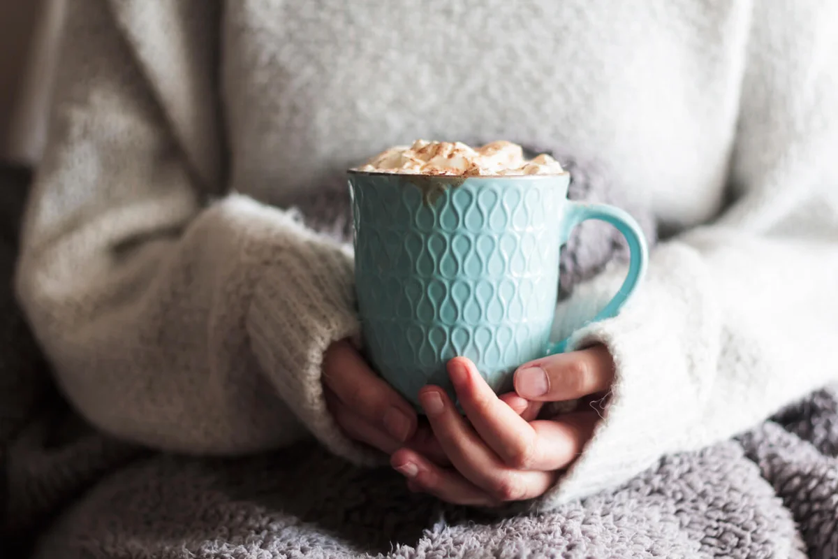 Woman Covered With Blanket Holding Mug