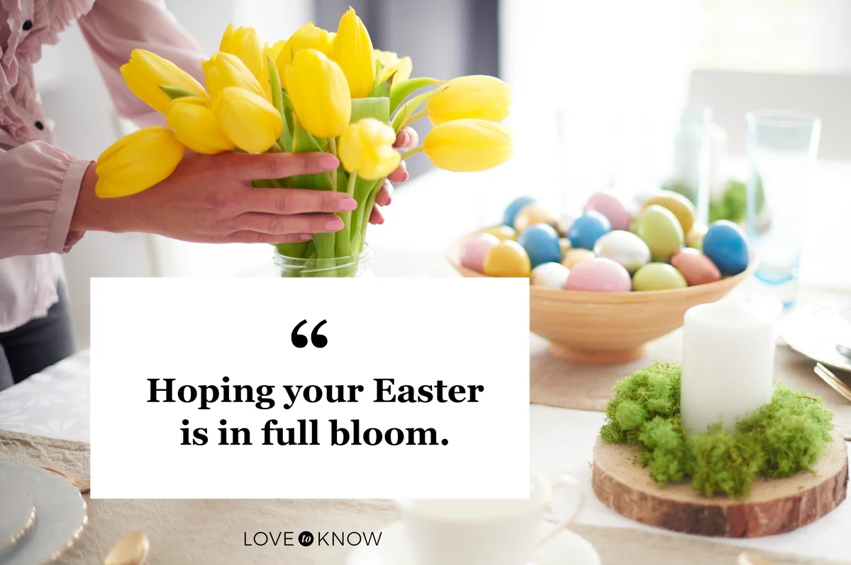 Hands of woman arranging yellow tulips at easter dining table