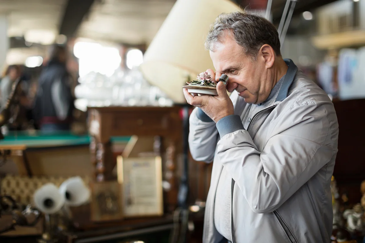 Male visiting antiques market and choosing old casket