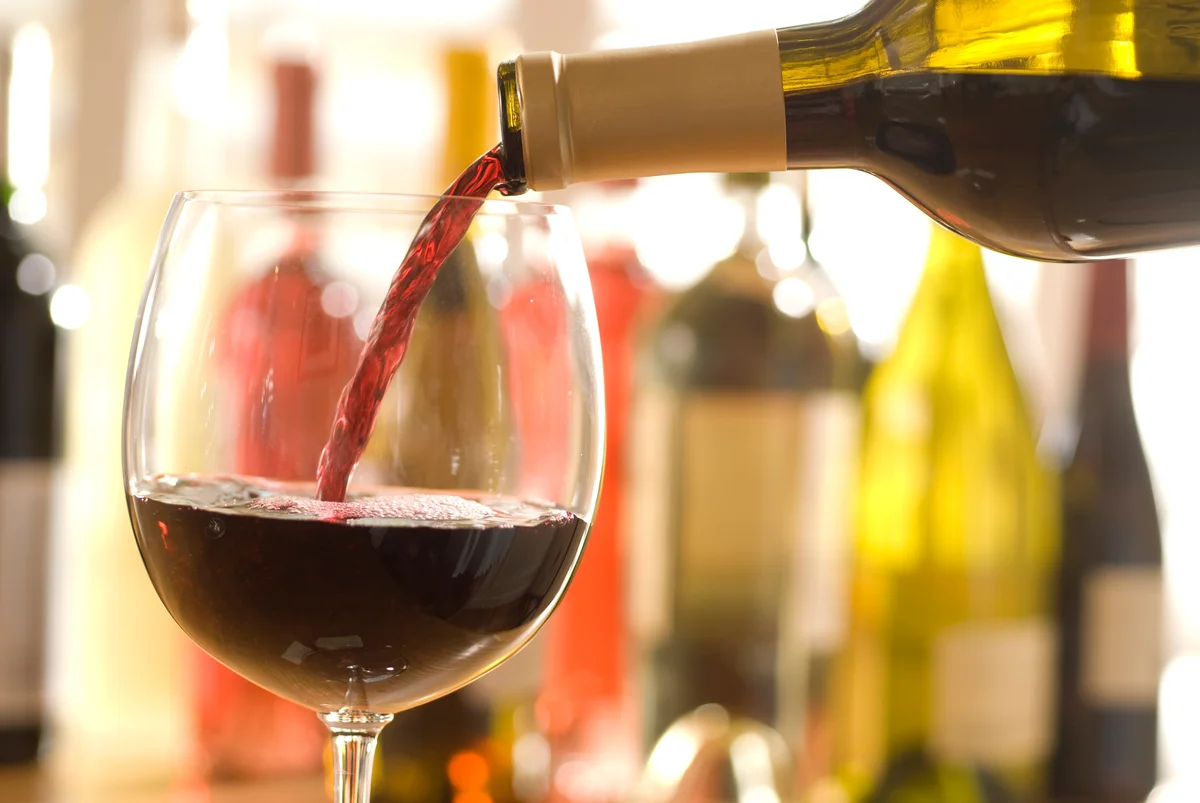 pour merlot wine in glass