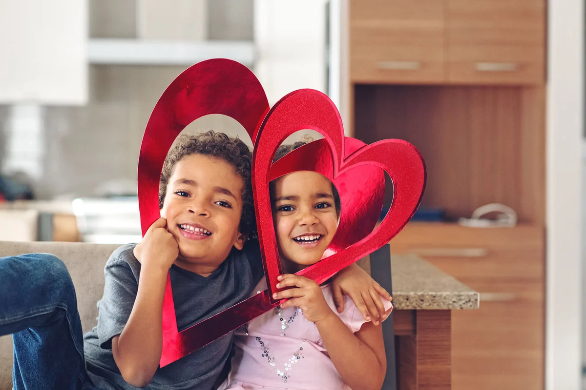 Kids playing with a heart frame shape