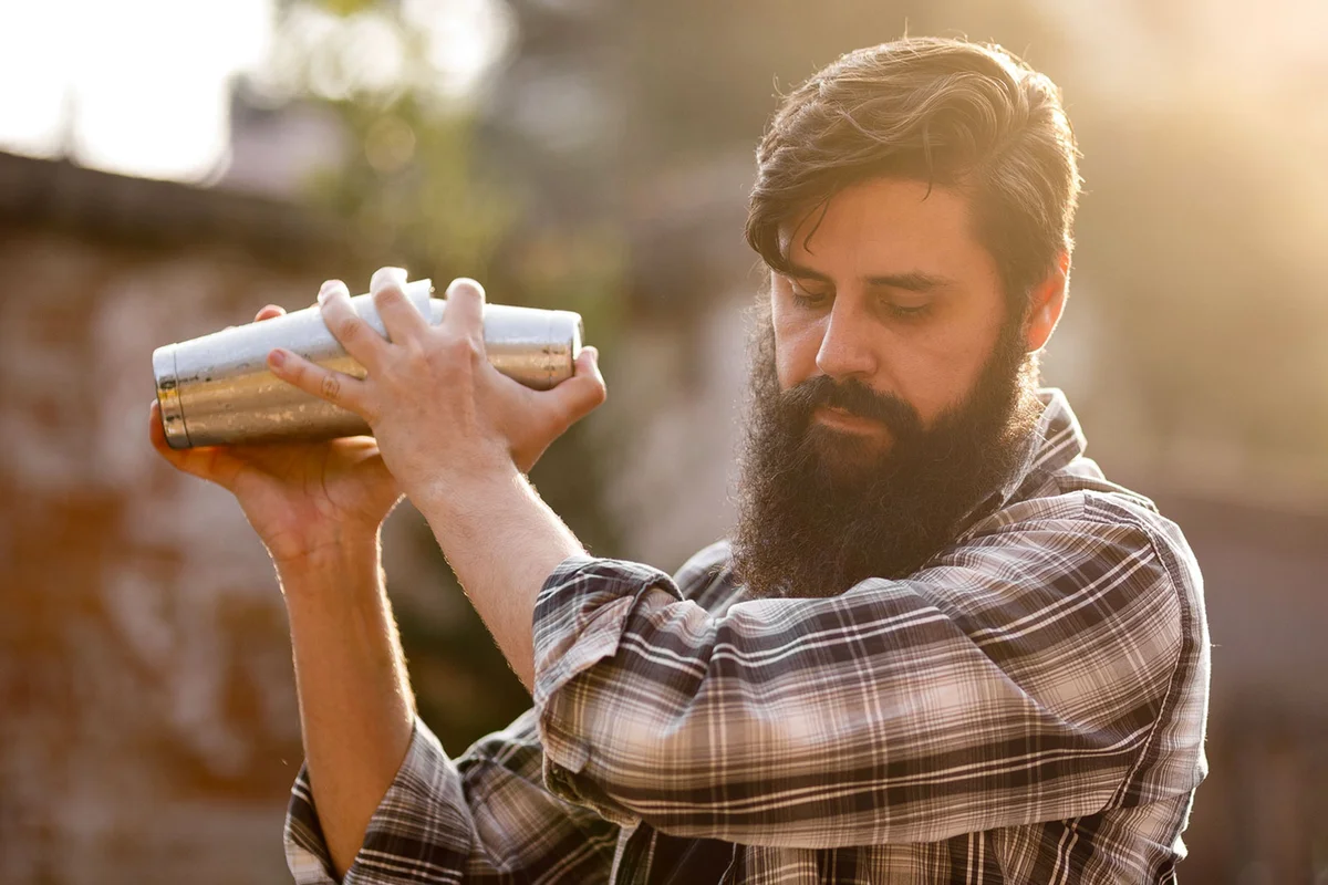 man demonstrating Boston Shaker for cocktails