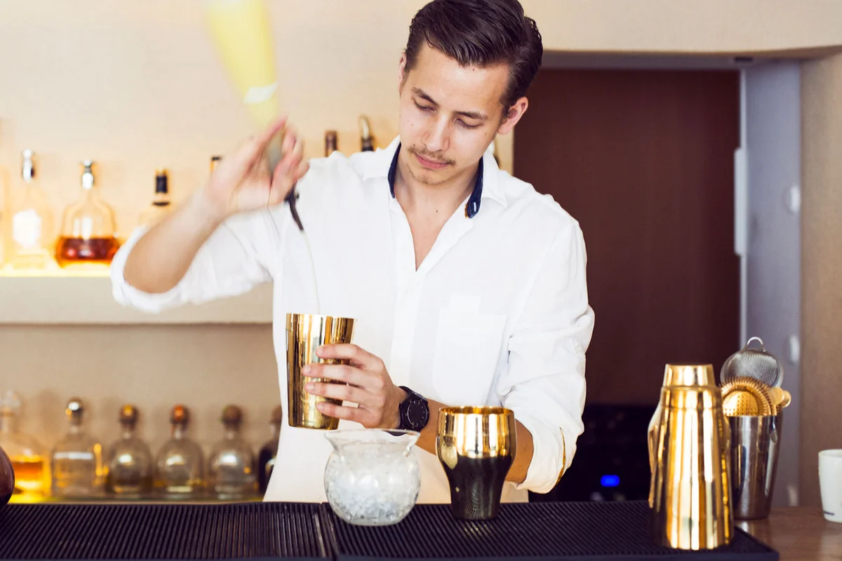 bartender demonstrating Parisian shaker for cocktails