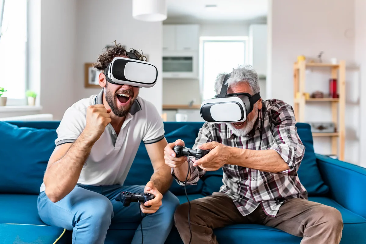 Father and Son in Vr Headsets Playing Video Games on Couch at Home