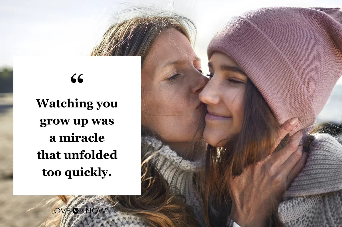 Mother kissing daughter on the beach