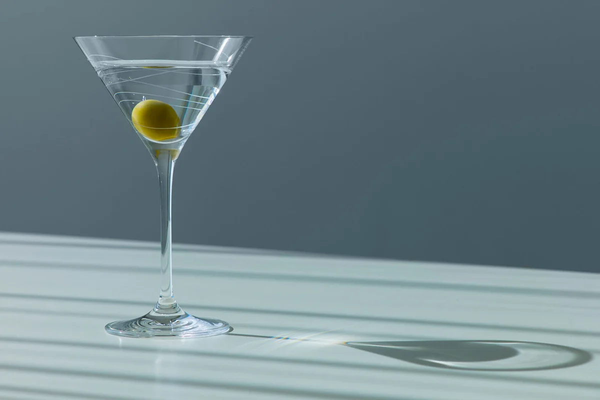 Cocktail with olive in glass
