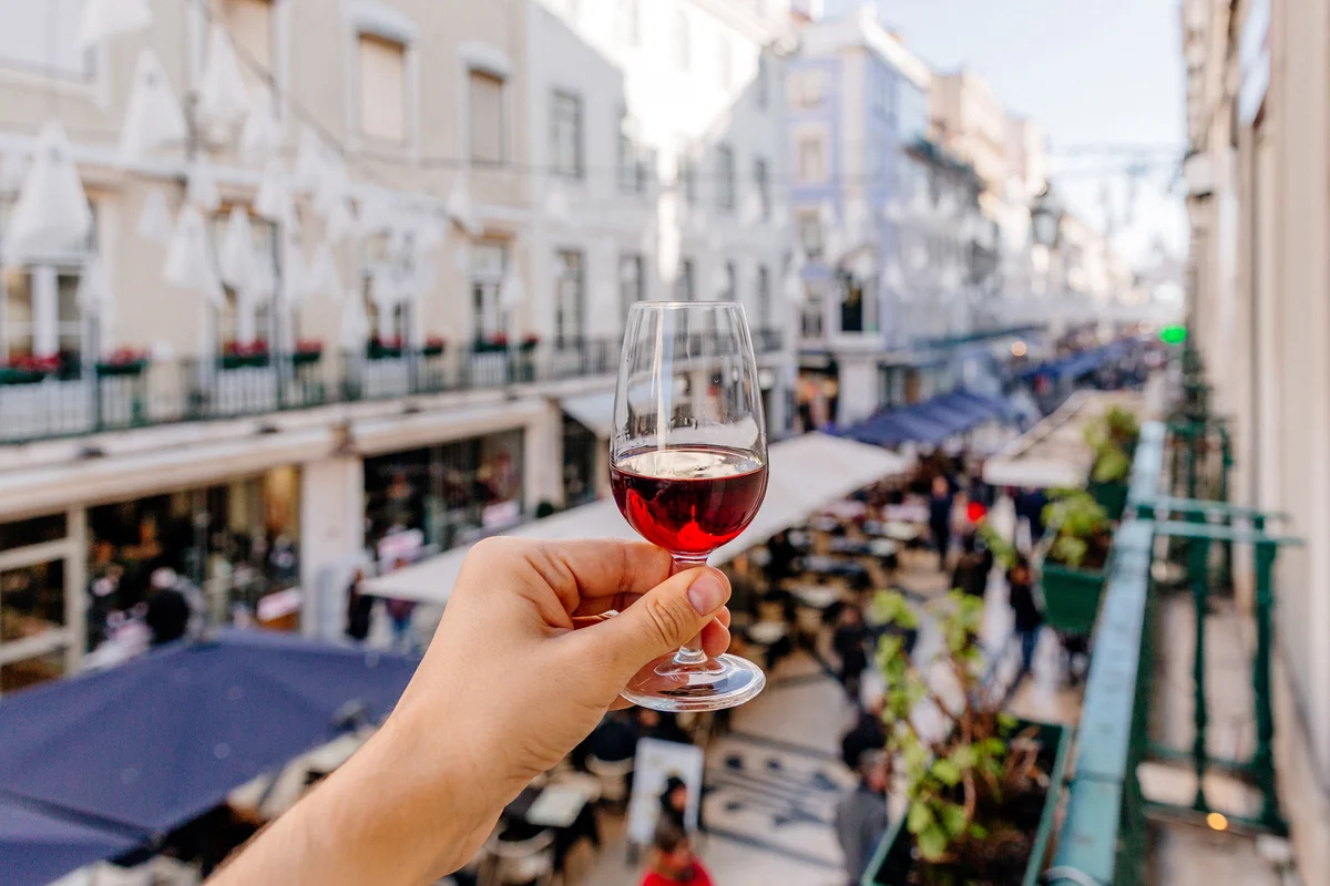 Man drinking port wine on a street in Lisbon