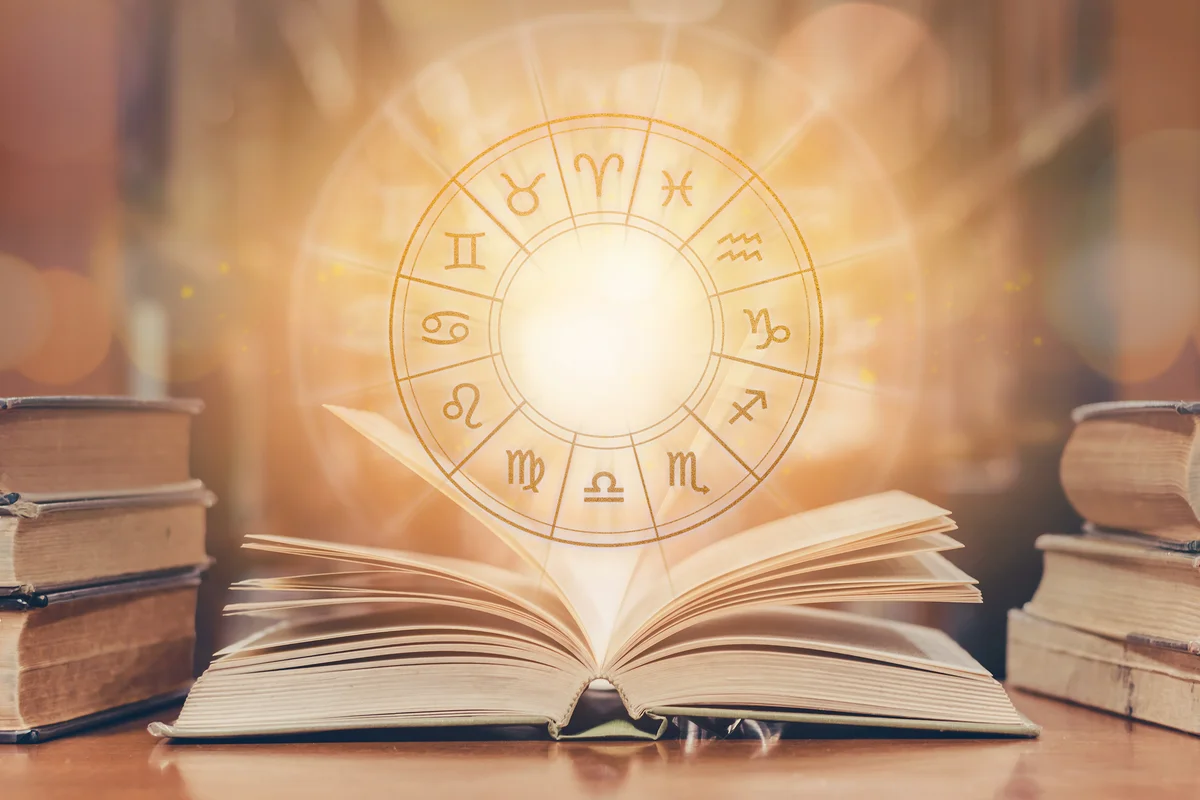 Horoscopic wheel over old book in school library
