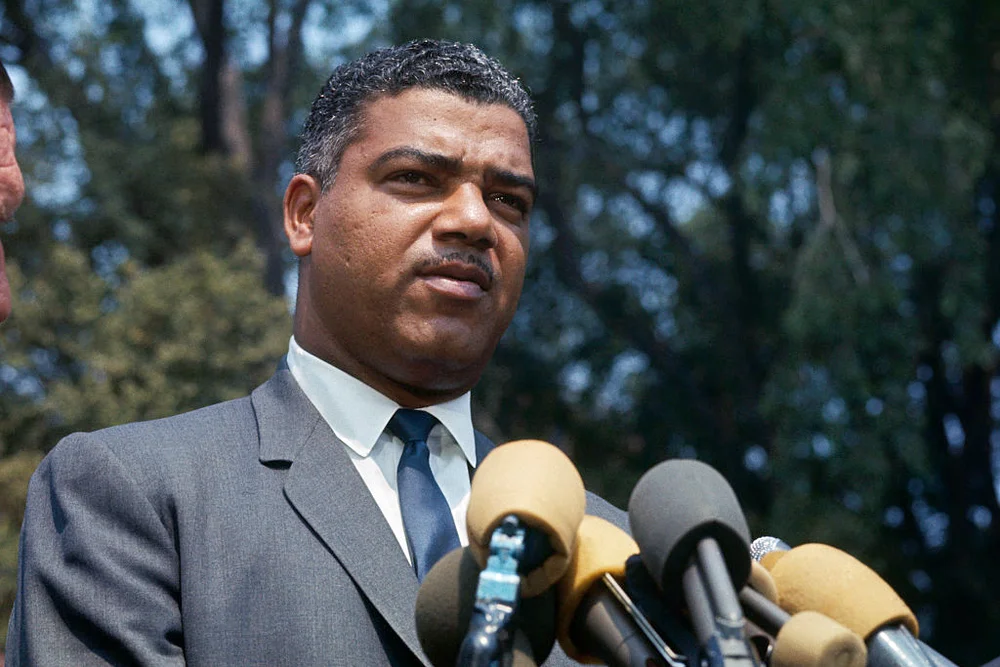 Whitney Young, executive director of the National Urban League, talks to newsmen