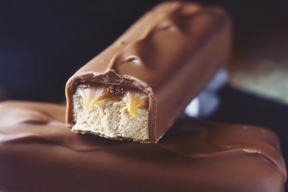 Two stacked milk chocolate bars with caramel and nougat filling