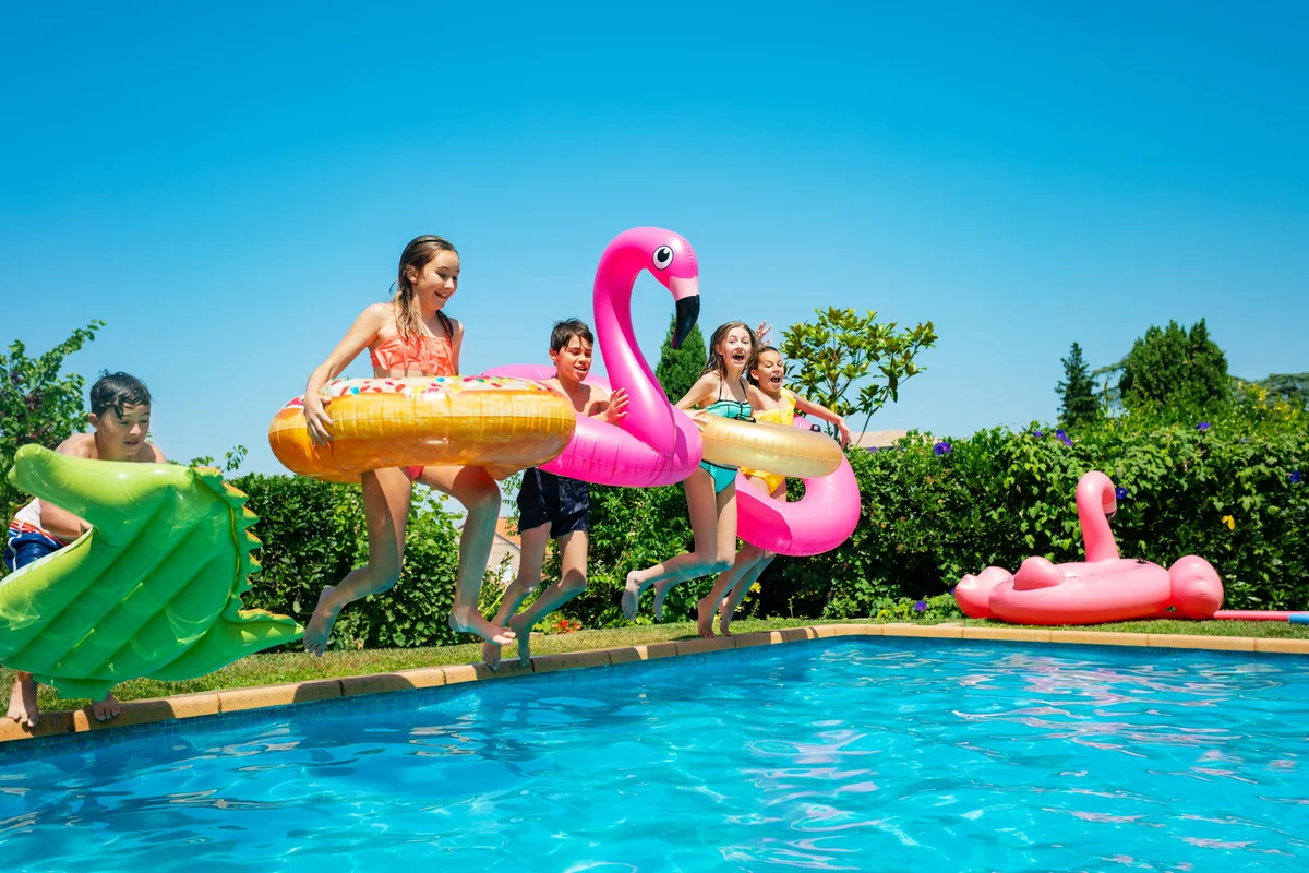 children jumping in pool together
