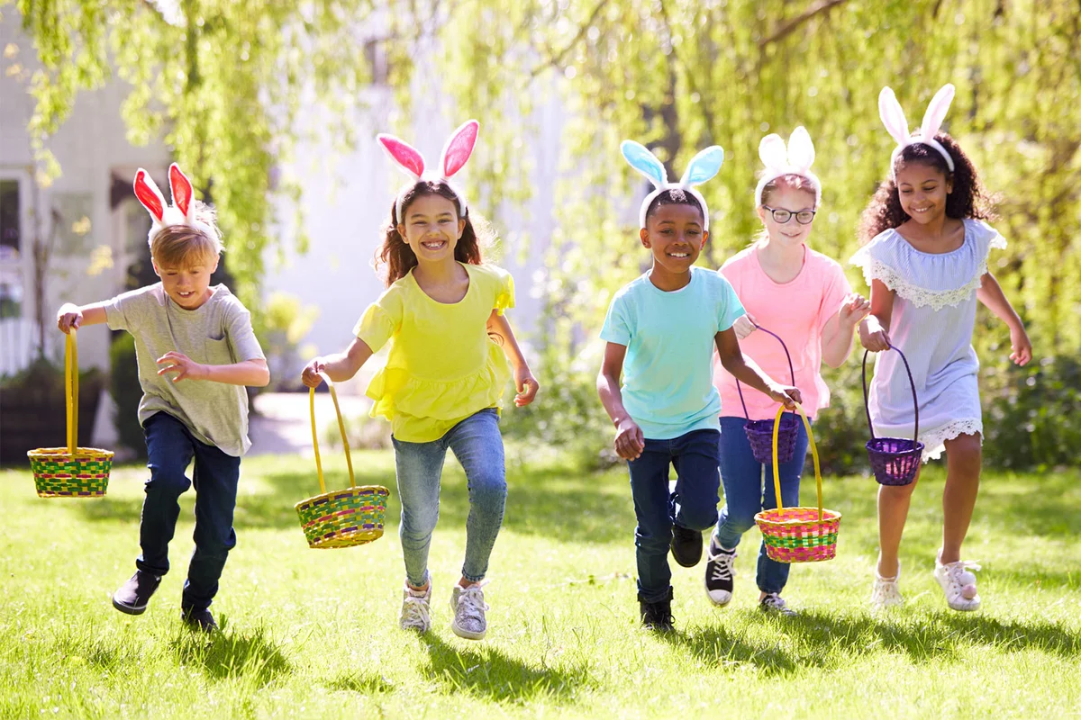 children running in yard at easter egg hunt