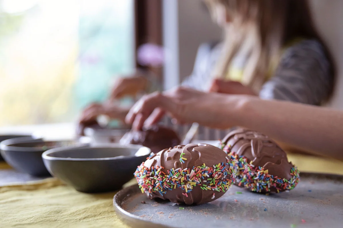decorate chocolate eggs with sprinkles