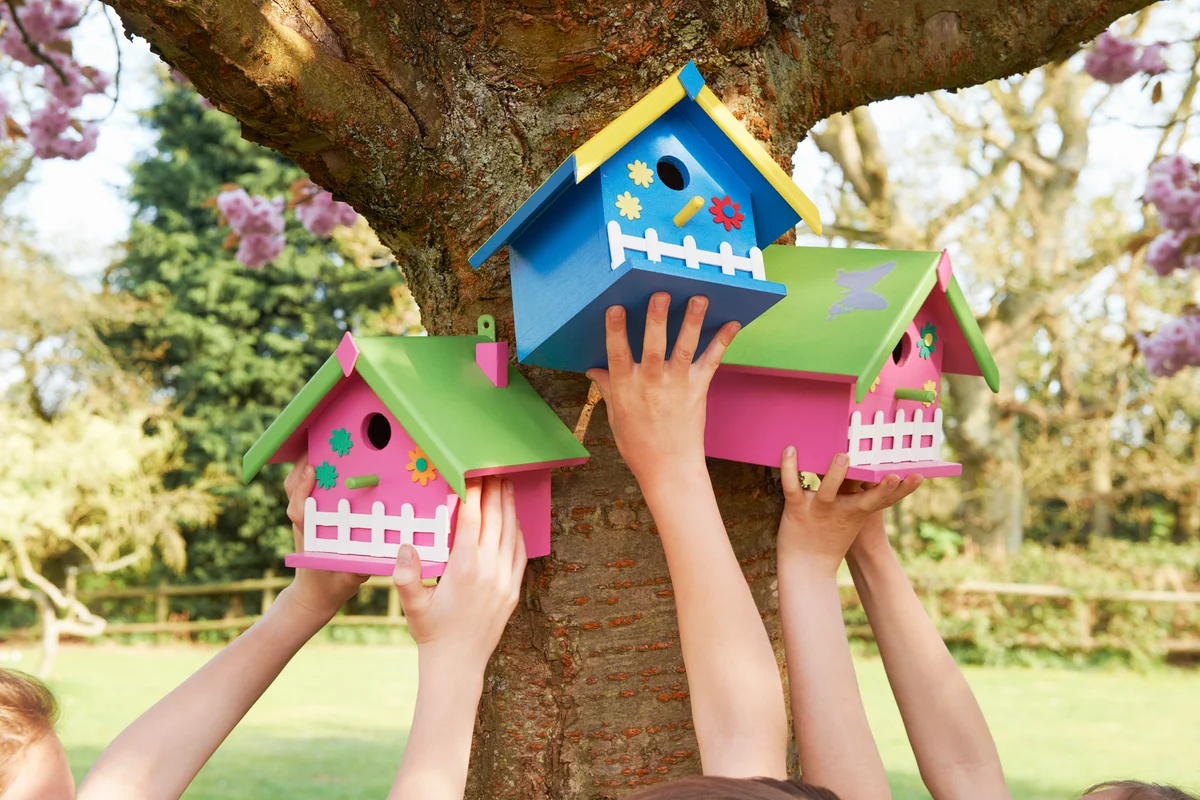 children with decorated birdhouses