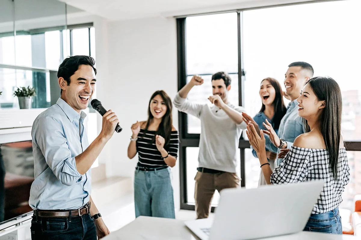 Group of Happy Young People Singing Karaoke