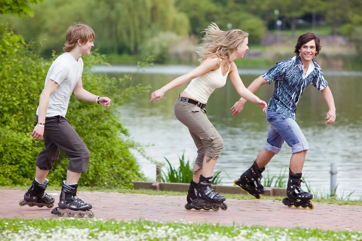 teenagers rollerblading in park
