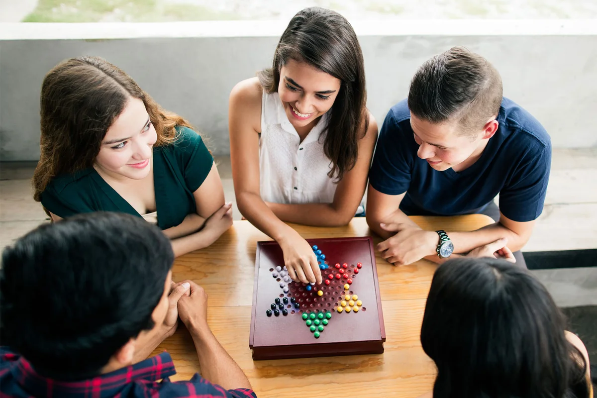 teenagers playing board game
