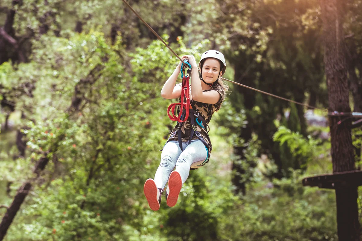teenage girl zip lining