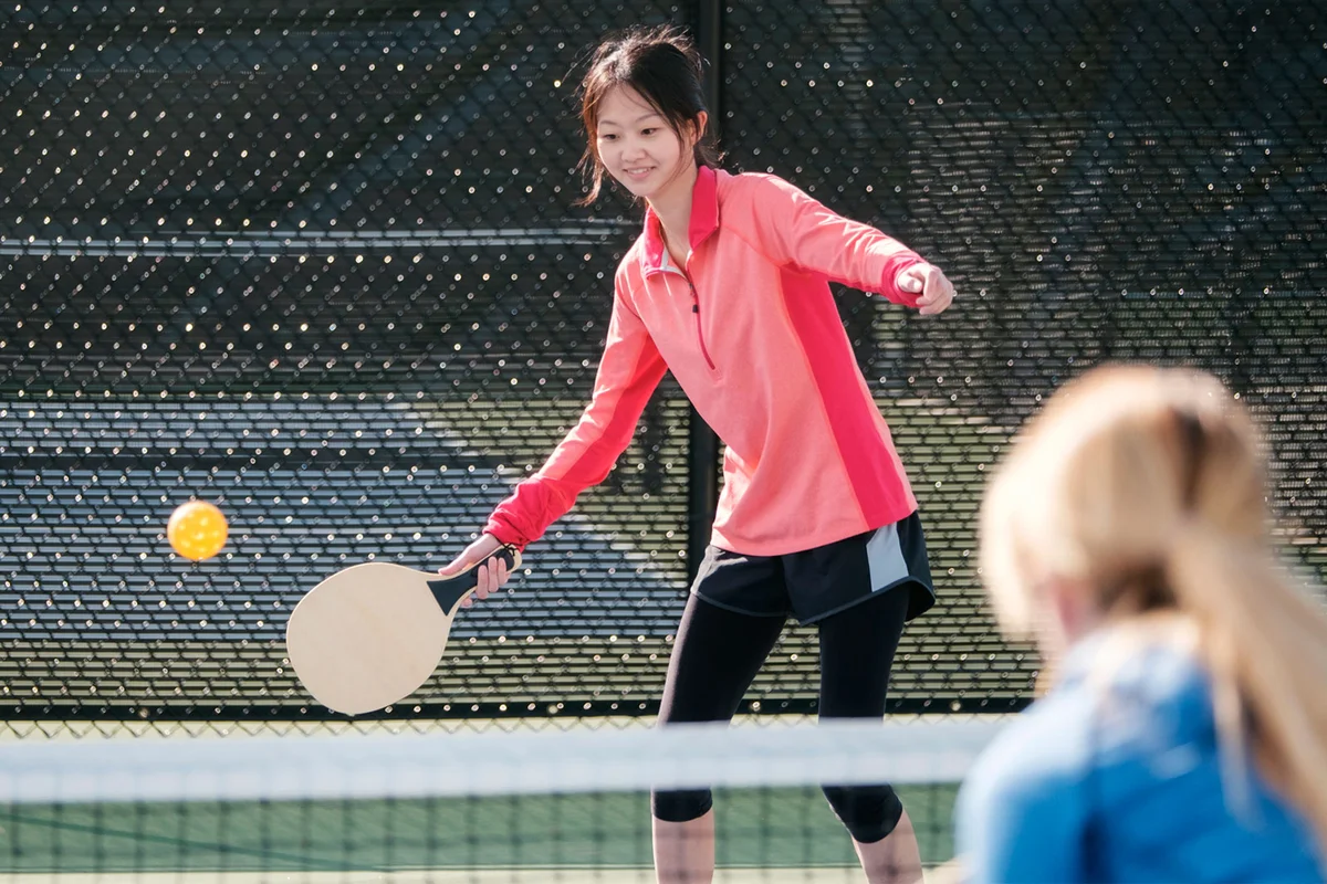 teenage girls playing pickle ball
