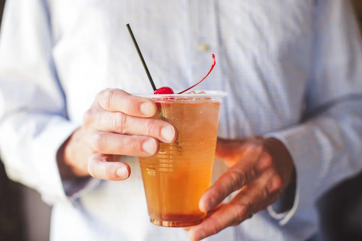 Hands holding a cocktail
