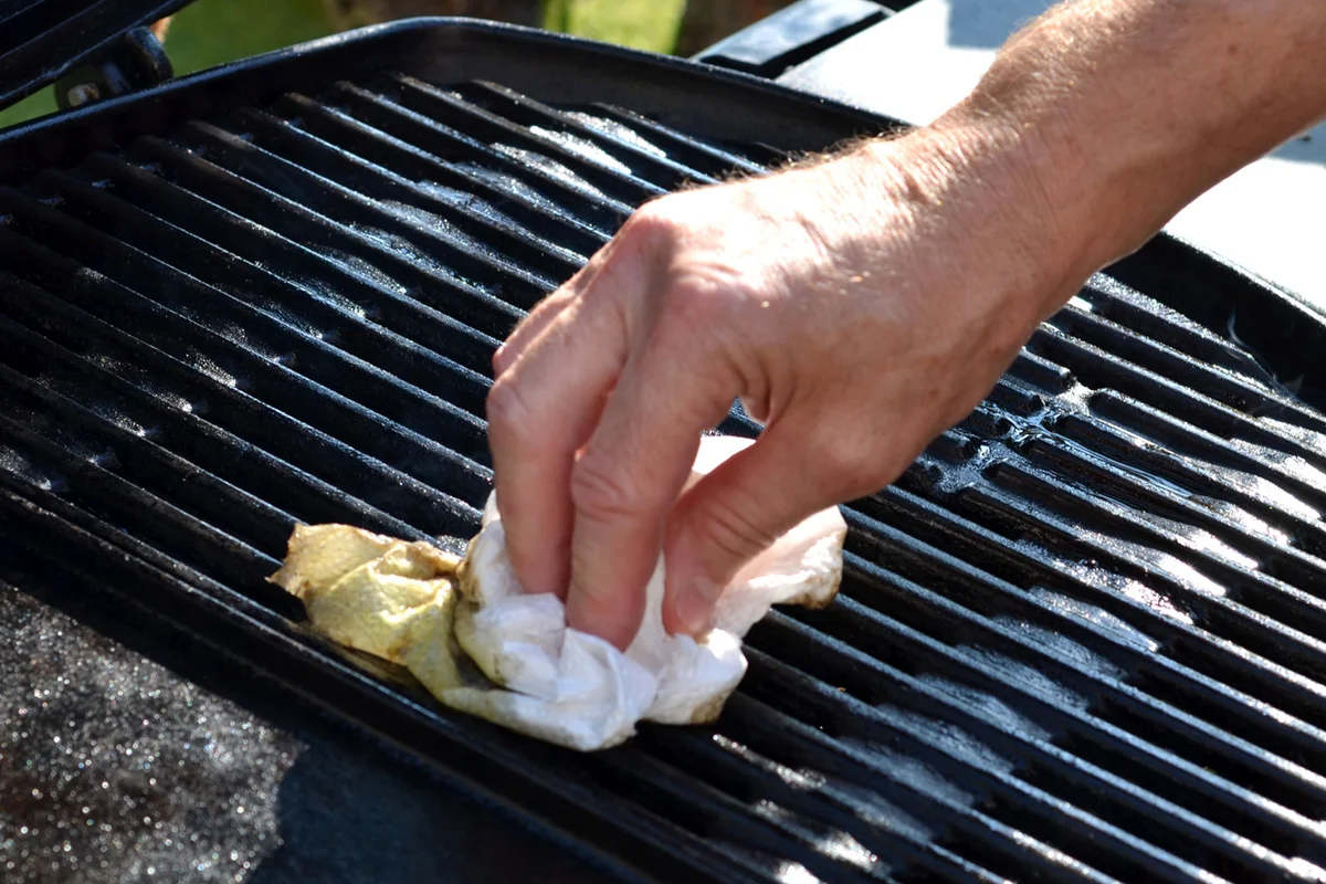 wipe clean grill grates with oil and cloth