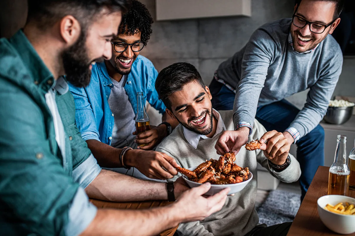 Friends at home eating fast food