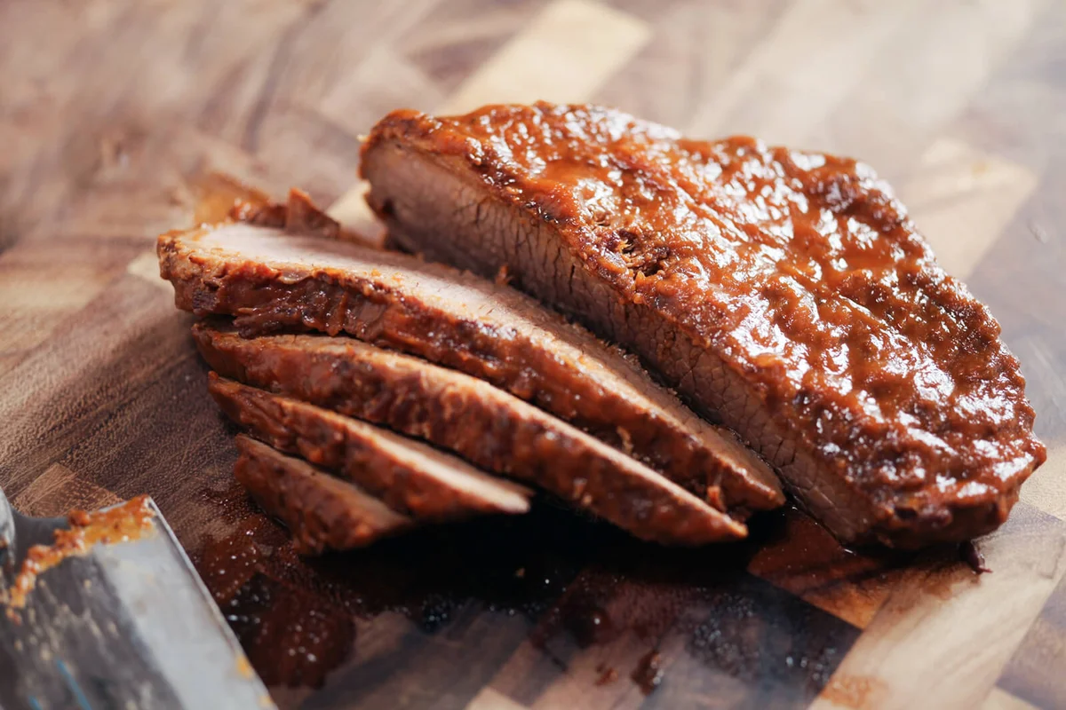 sliced brisket on wooden cutting board
