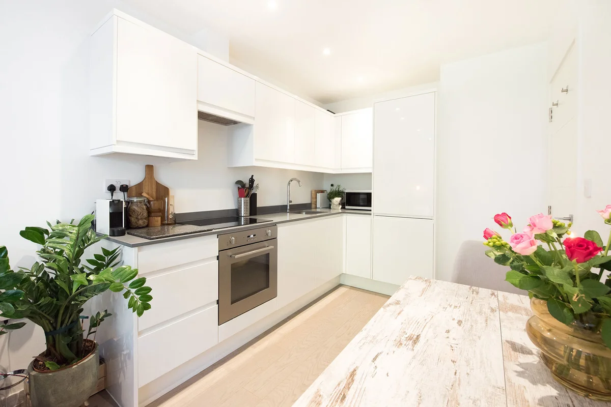 small kitchen white walls and cabinets