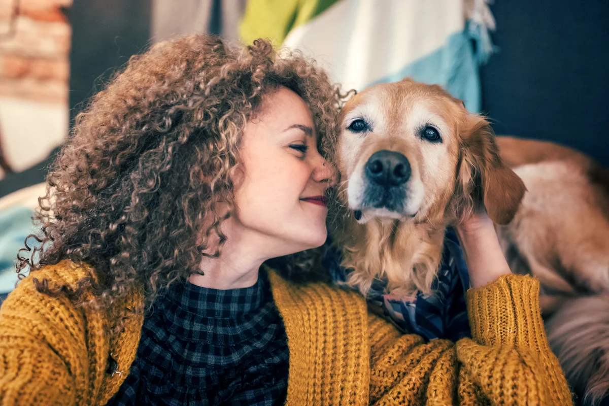 Woman cuddling with her dog