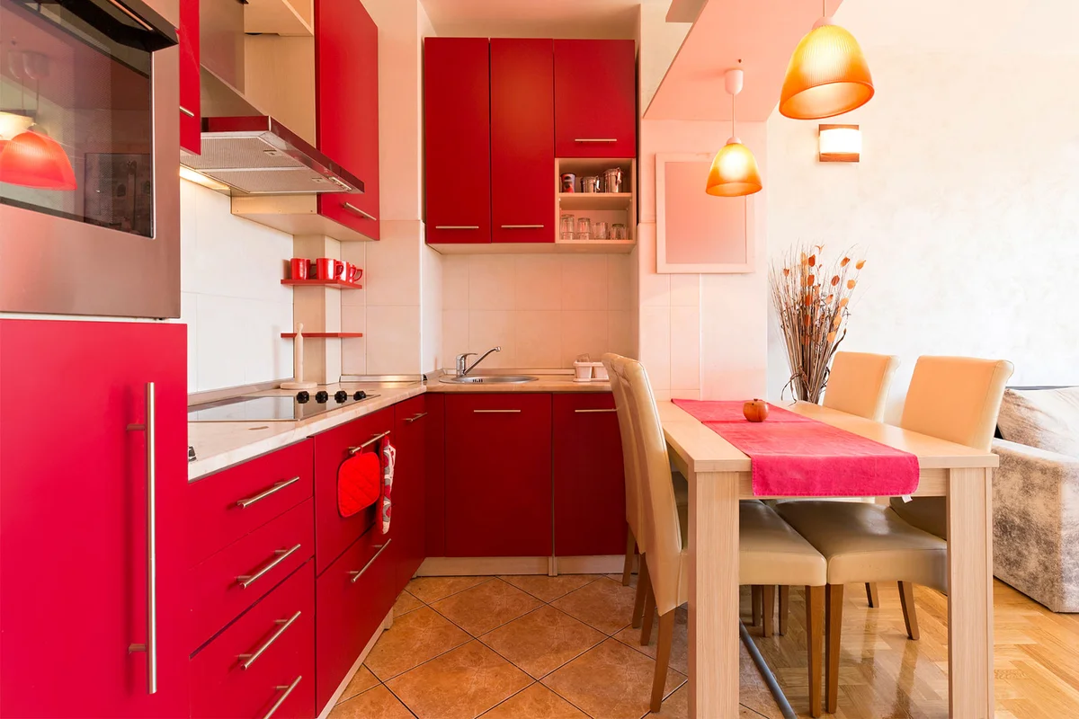 small kitchen with red cabinets
