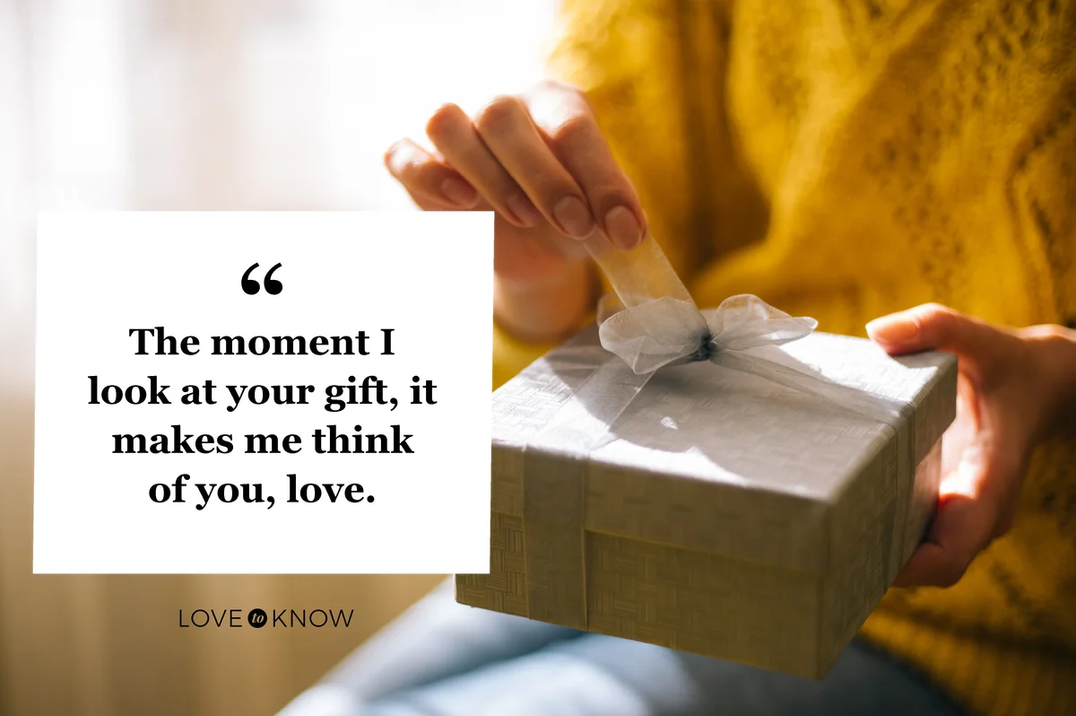 Young woman in yellow sweater opening gift box