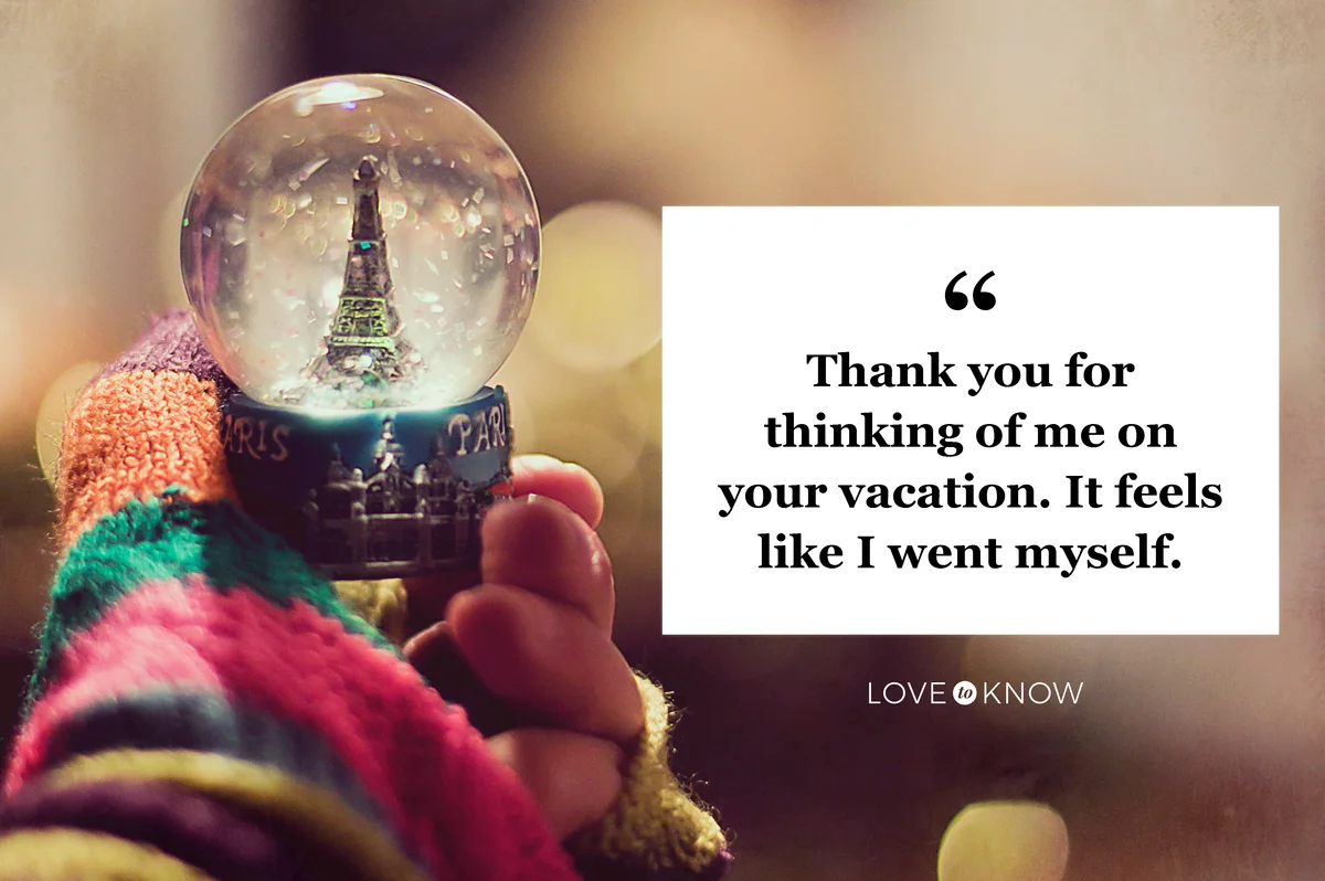 Woman hand holding Eiffel tower snow globe